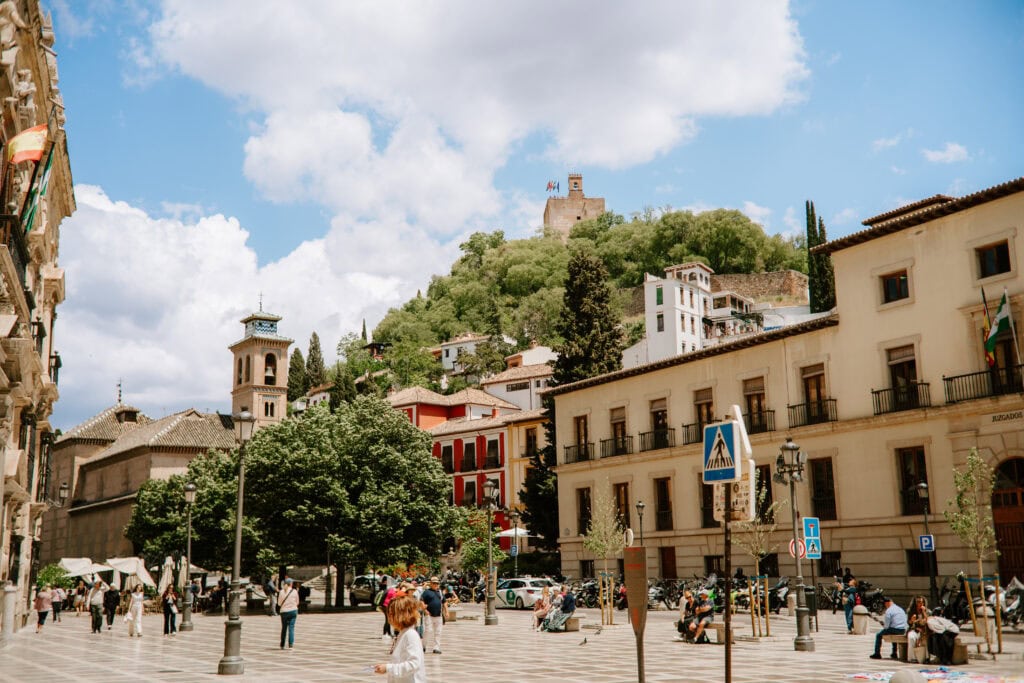 Scenic plaza with people and historic buildings.