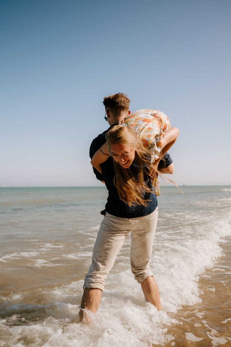 Couple playing in the sea waves