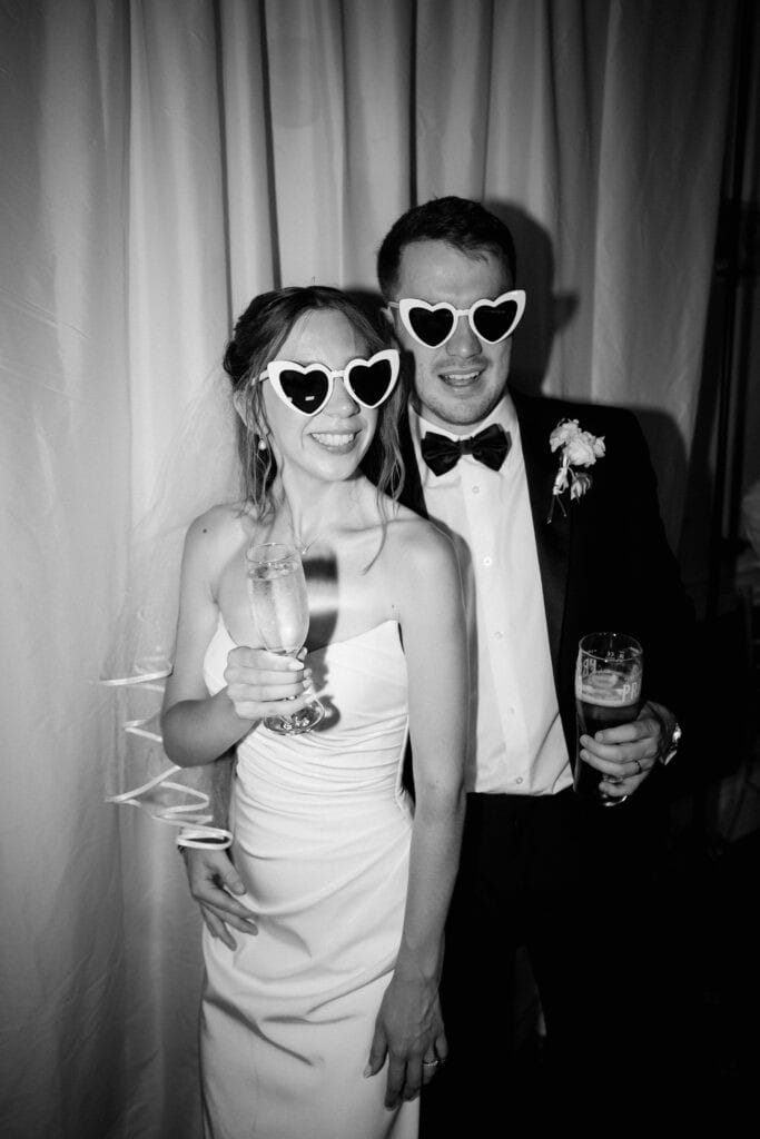 Couple wearing heart sunglasses at wedding celebration