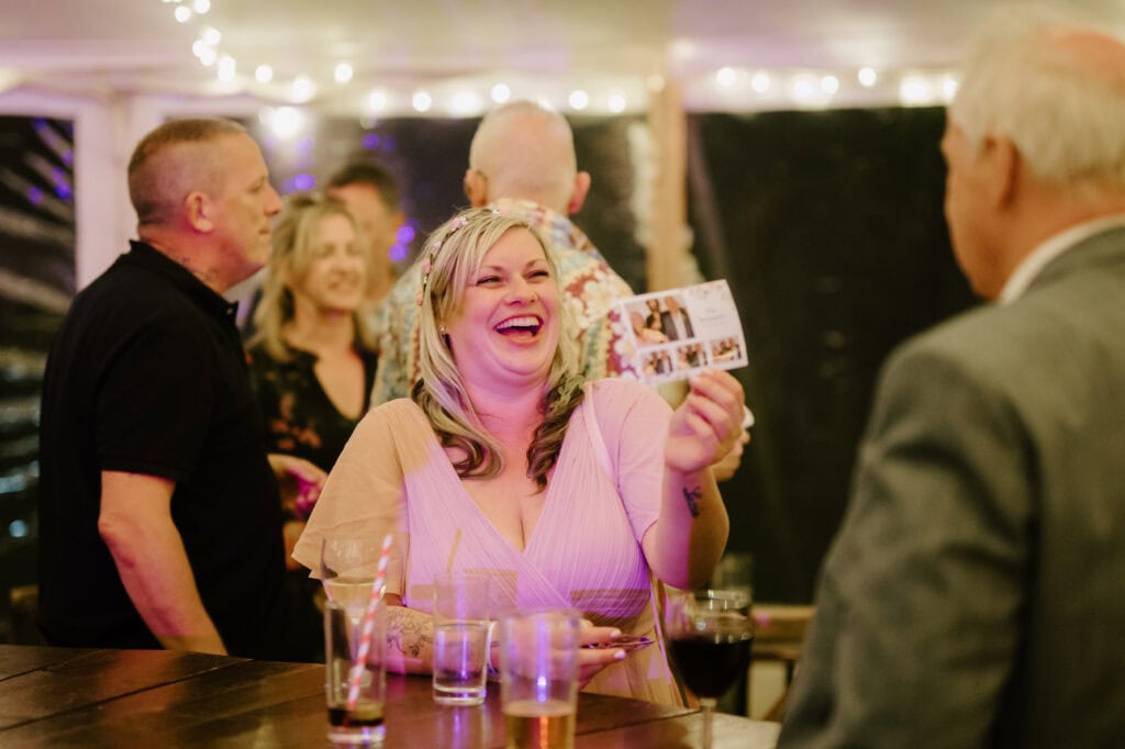 Woman laughing with friends at a party.