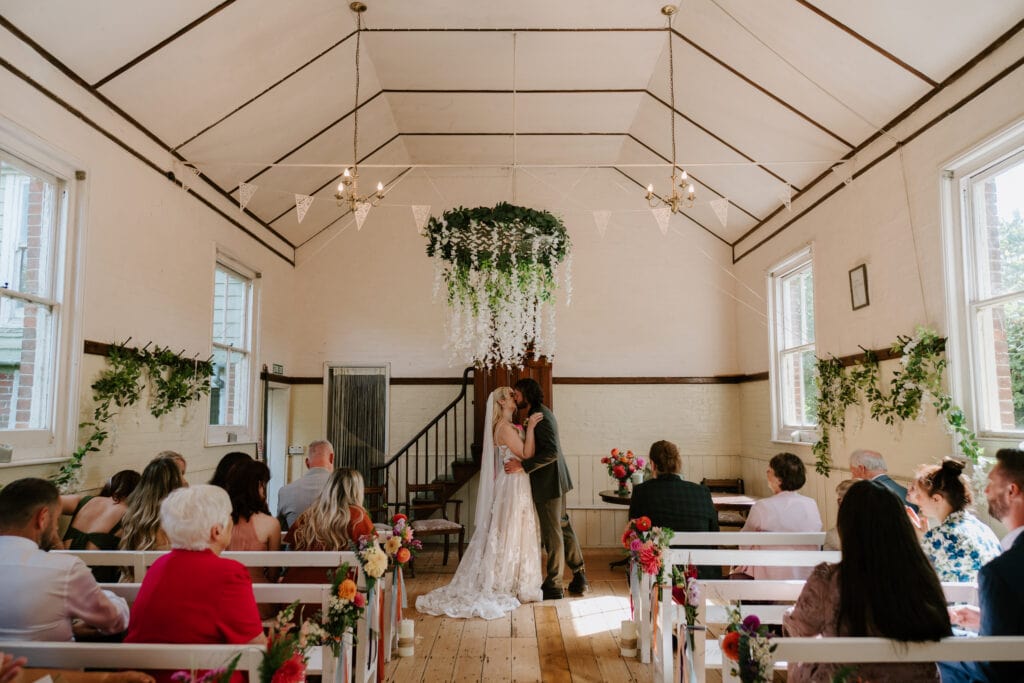 Wedding ceremony in a decorated rustic venue.