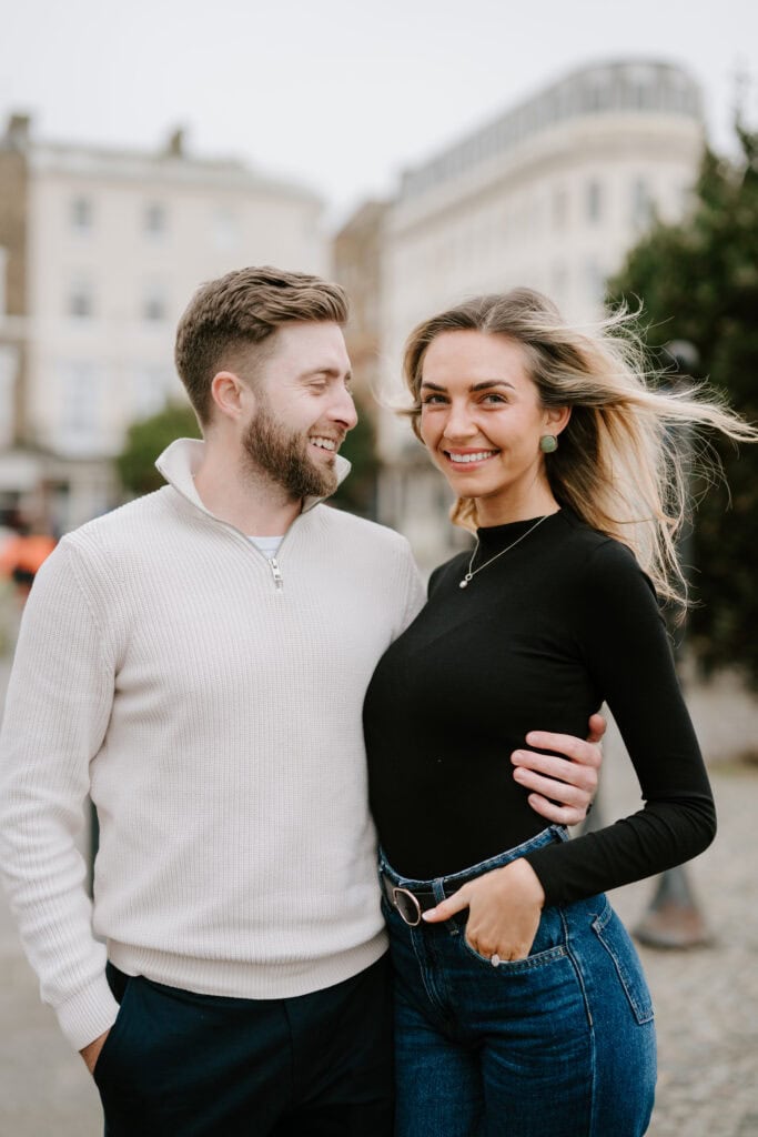 Smiling couple standing outdoors with buildings behind in margates old town