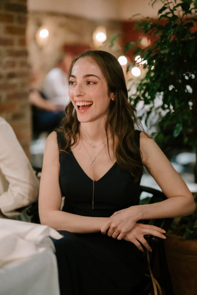 Woman smiling at dinner table