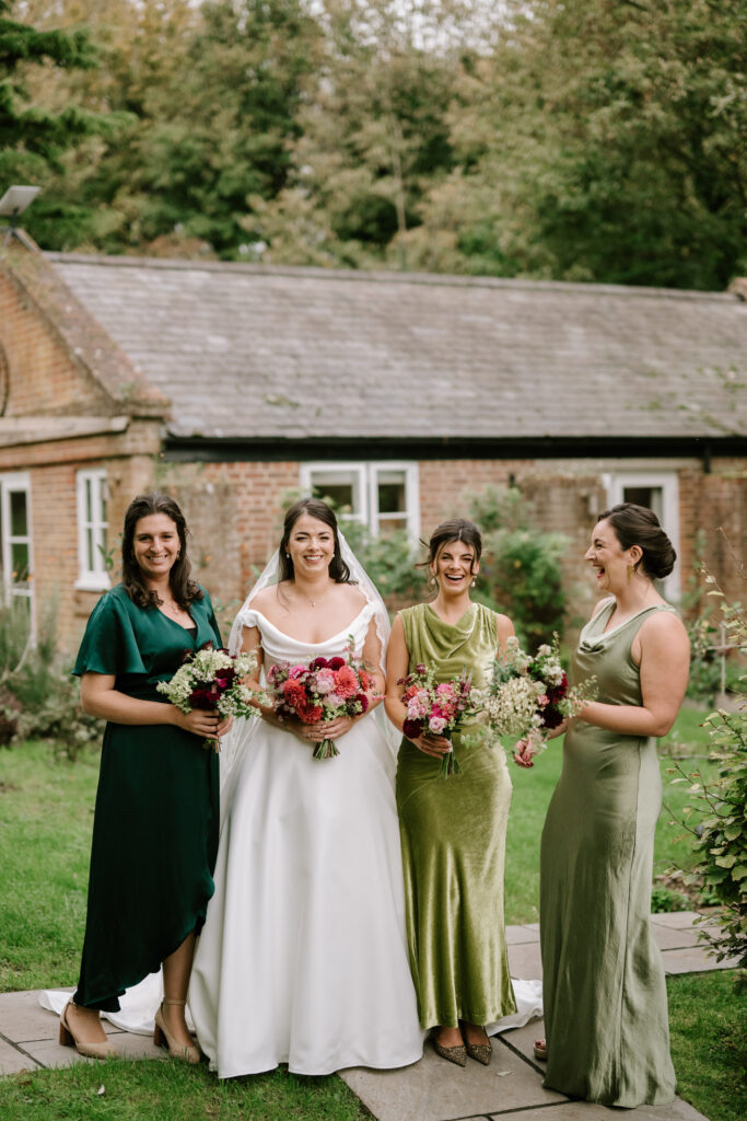 Bride and bridesmaids in garden with bouquets at updown farmhouse