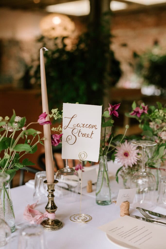 Elegant wedding table setting with flowers and candle.