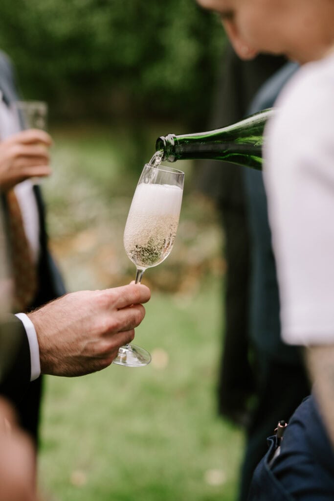 Pouring champagne into a flute at celebration.