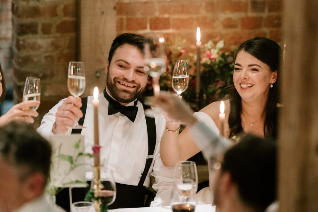 Guests enjoying wedding toast with champagne glasses.