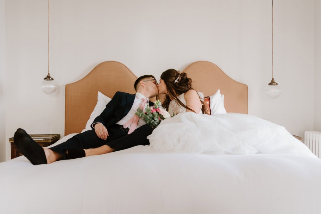 Wedding couple kissing on a bed