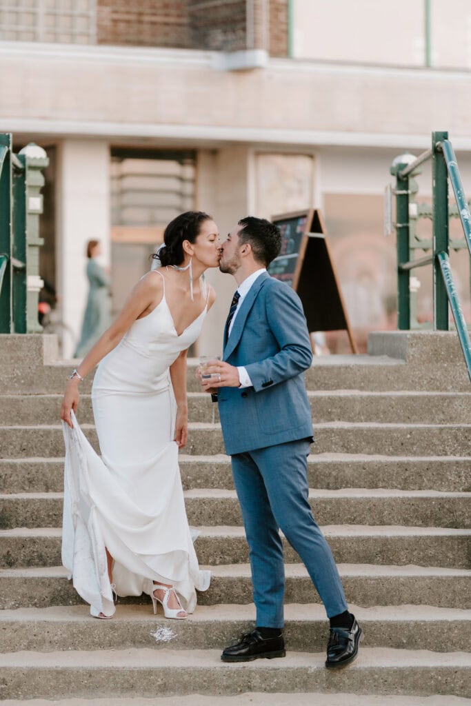 Bride and groom kissing on steps