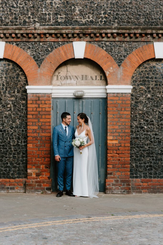 Couple poses outside margate Town Hall after wedding ceremony.