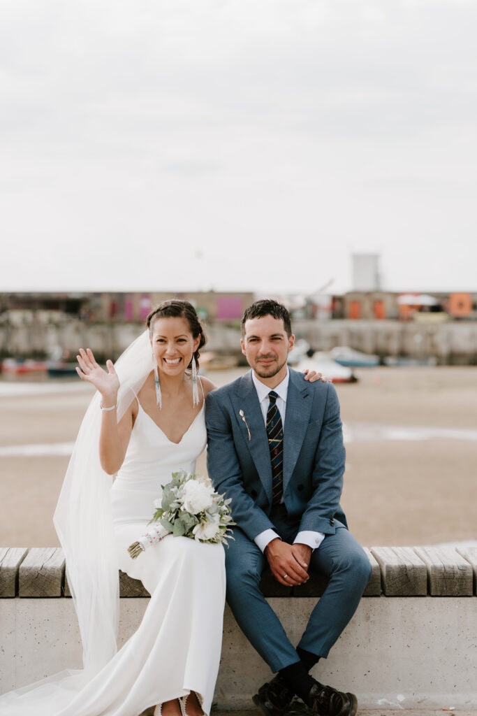 Smiling bride and groom on margate beach wedding day.