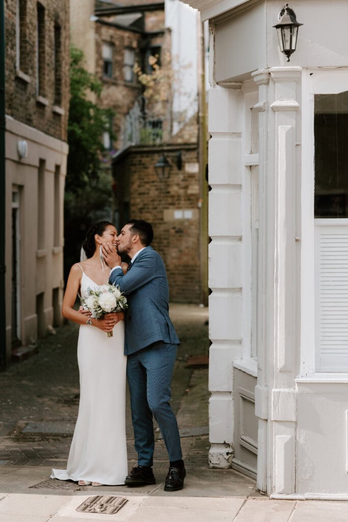 Couple kissing on wedding day in margate old town