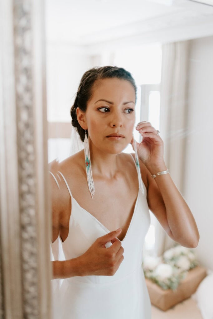 Bride adjusts earrings before margate wedding ceremony.