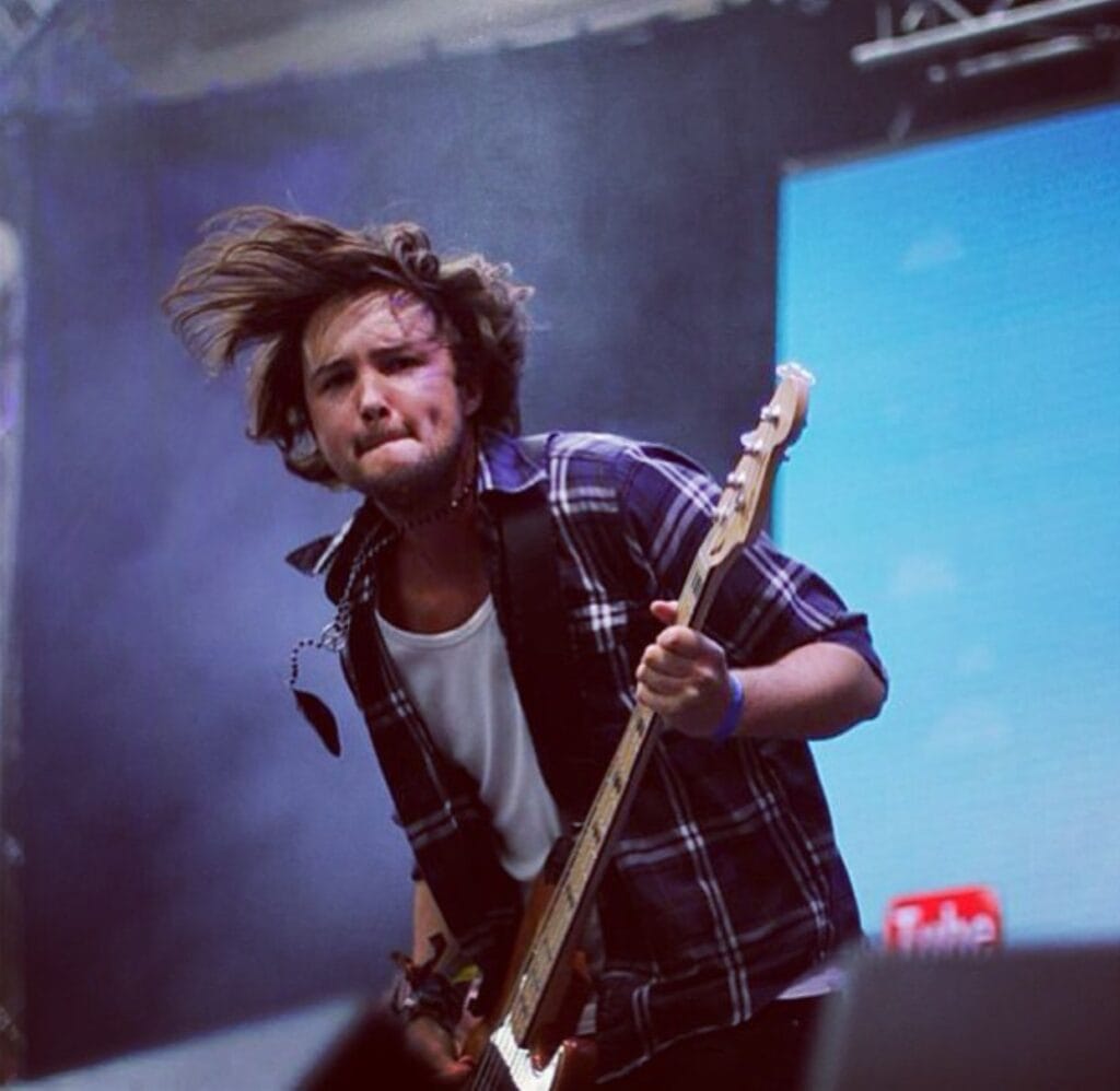 Bass guitarist performing energetically on stage