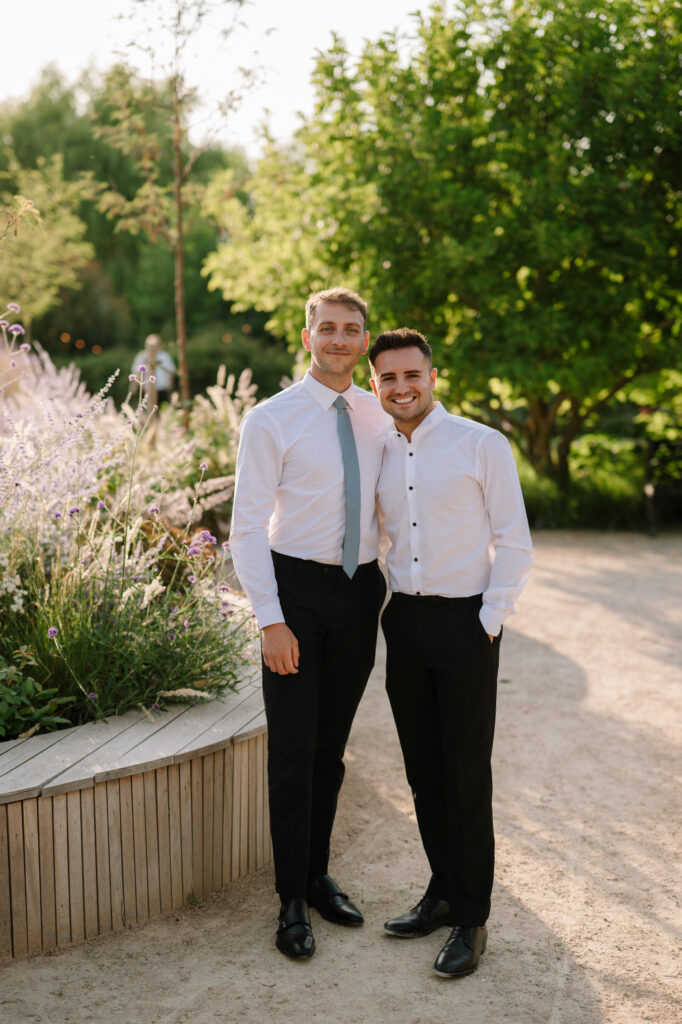 Two men smiling in garden setting