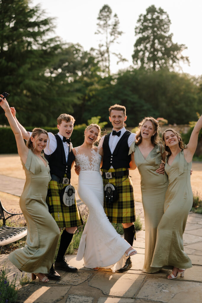 Wedding party celebrating outdoors in garden setting